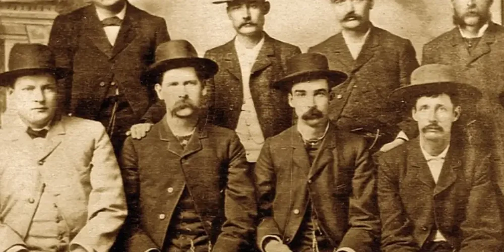 legendary-oklahoma-lawmen Bat Masterson (standing second from right), Wyatt Earp (sitting second from left), and other deputy marshals during the Wild West era